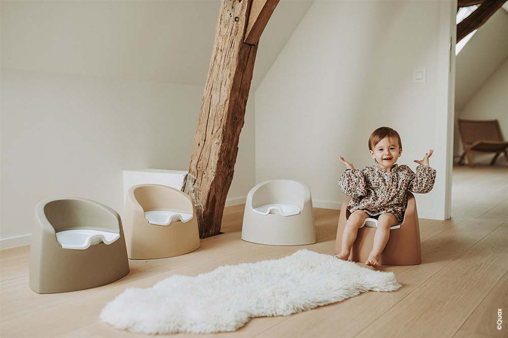 Bébé heureux et fier sur le pot, entouré de trois autres pots dans une chambre lumineuse, techniques d'apprentissage du pot