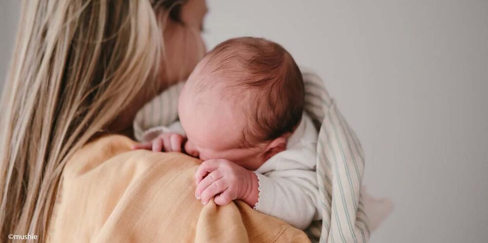 Moment peau à peau au retour maison après naissance, premiers instants avec bébé et installation du quotidien post‑maternité